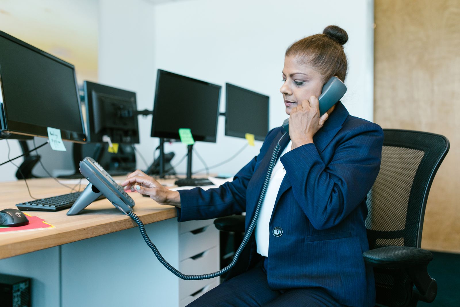 Office professional answering a desk phone